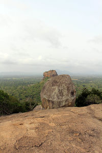 Rock formations on landscape against sky