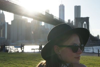 Portrait of young woman wearing sunglasses in city