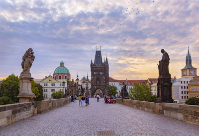 Charles bridge, old town tower and statues at sunrise, prague, czech republic