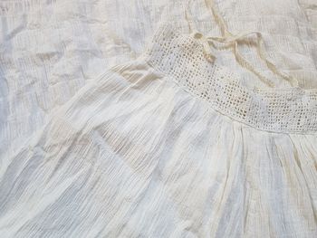 High angle view of white cloth on bed