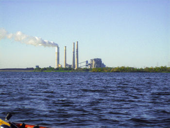 Smoke emitting from chimney against clear sky