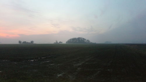 Scenic view of field against sky during sunset