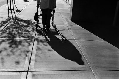 Low section of people walking on sidewalk