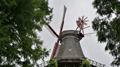 Low angle view of traditional windmill against sky