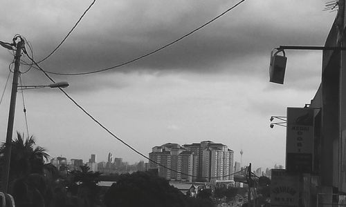 Low angle view of buildings against cloudy sky