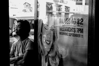 Rear view of woman with text in store