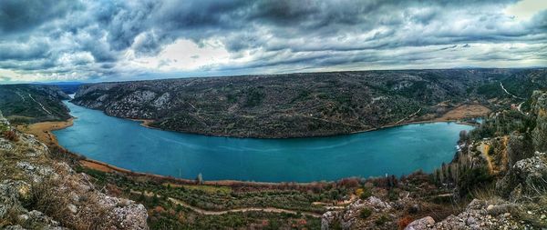 Scenic view of lake against cloudy sky