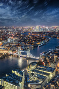 Aerial view of illuminated city against sky