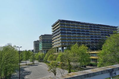Low angle view of buildings against clear blue sky