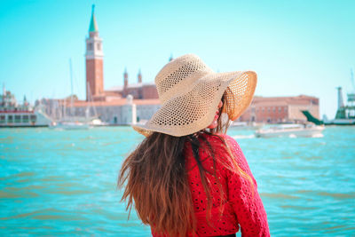 Rear view of woman wearing hat against sky