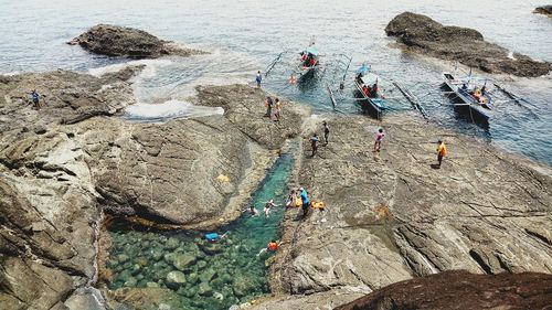 High angle view of people working on rock