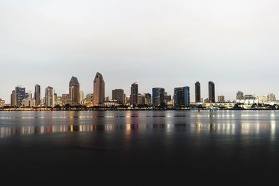 View of city by sea against sky