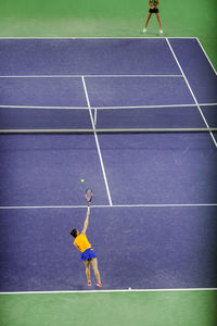 High angle view of women playing tennis on court