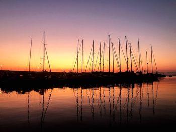 Sailboats in marina at sunset