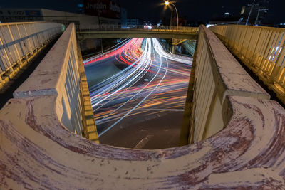 Light trails seen from u-shaped pedestrian bridge