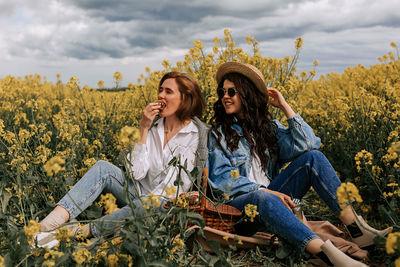 Flowers in a field with beautiful girls. huge selection of tulips and rapeseed