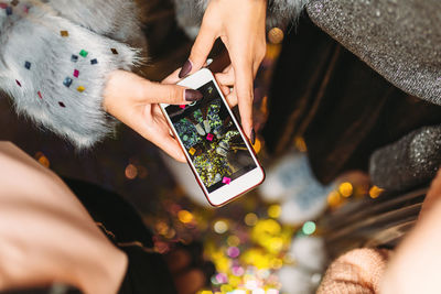 Midsection of woman using mobile phone