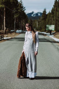 Woman wearing sunglasses standing on road