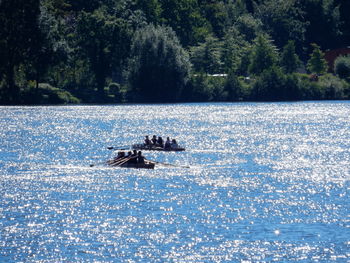 Boat in river against trees