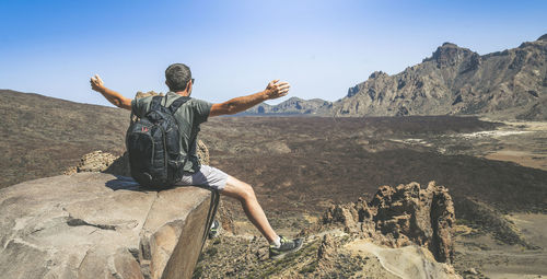 Side view of man standing on rock