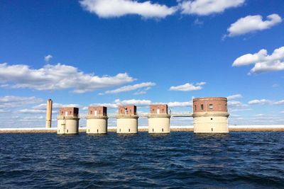 Building by sea against sky