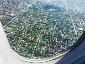 Aerial view of cityscape seen through airplane window