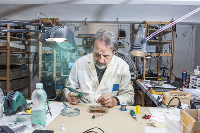 Electronic engineer in the laboratory with a soldering iron