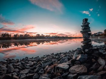 Scenic view of lake against sky at sunset