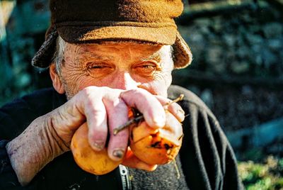 Portrait of man holding hat