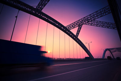 Low angle view of bridge against sky during sunset