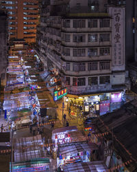 High angle view of illuminated street amidst buildings in city