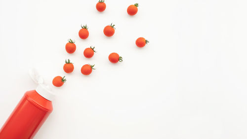 High angle view of multi colored candies against white background