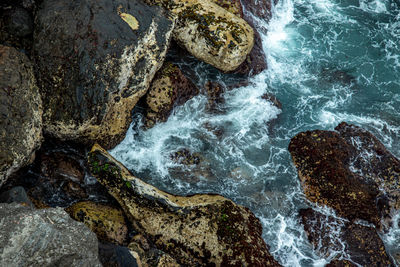 High angle view of rocks in sea