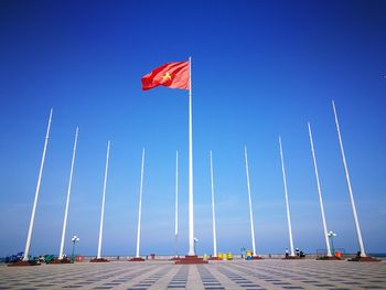 Low angle view of vietnamese flag against blue sky