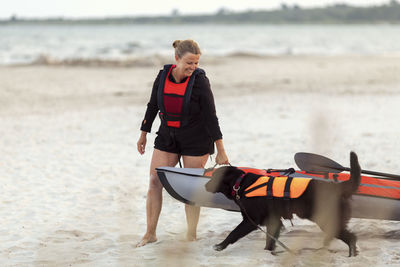 Woman with dog on beach