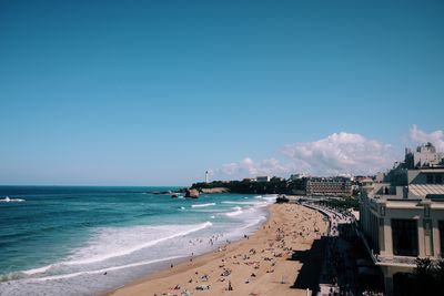 Scenic view of beach against blue sky