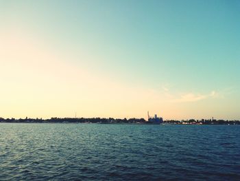 Scenic view of sea against clear sky during sunset