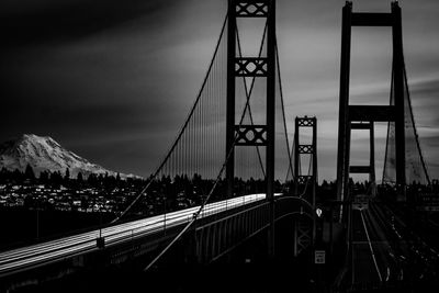 View of suspension bridge against cloudy sky