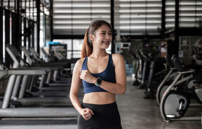 Young woman exercising in gym