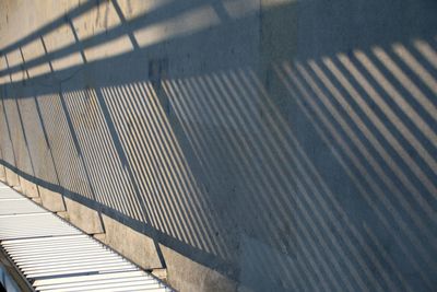 High angle view of shadow on railing