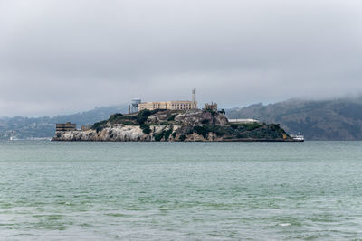 Scenic view of sea and buildings against sky