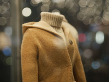 Close-up of warm coat for sale at store