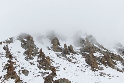 Scenic view of snow covered mountains against sky