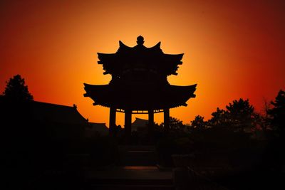 Silhouette temple against sky during sunset