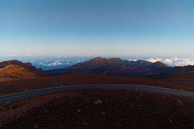 High angle view of mountain road against blue sky