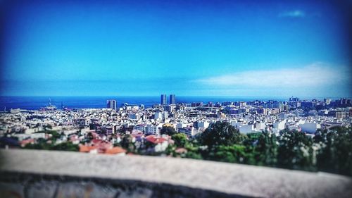 Panoramic view of cityscape against clear blue sky