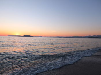 Scenic view of sea against clear sky during sunset