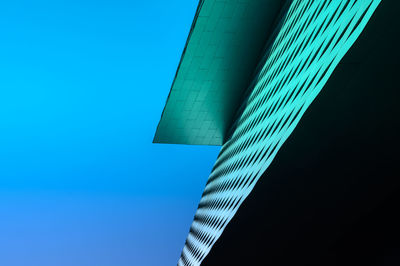 Low angle view of modern building against clear blue sky