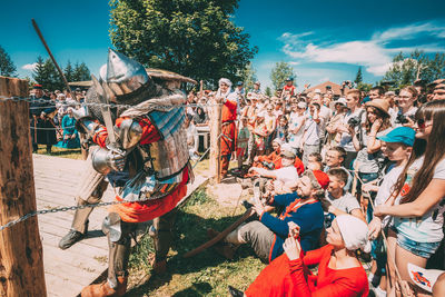 Group of people in traditional windmill against sky