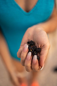 Close-up of hand holding berries